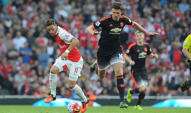 Месут Езил и Майкл Каррик, Getty Images