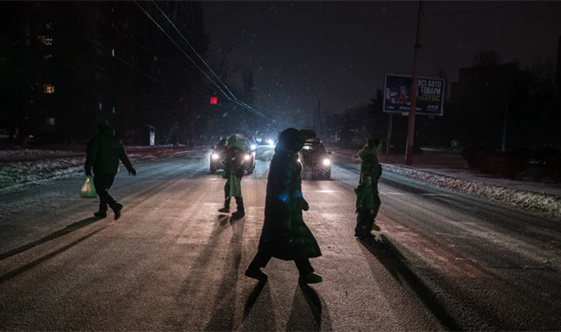 People cross the street during a power outage, getty images
